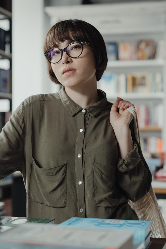 Woman in Green Button Up Long Sleeve Shirt Wearing Eyeglasses