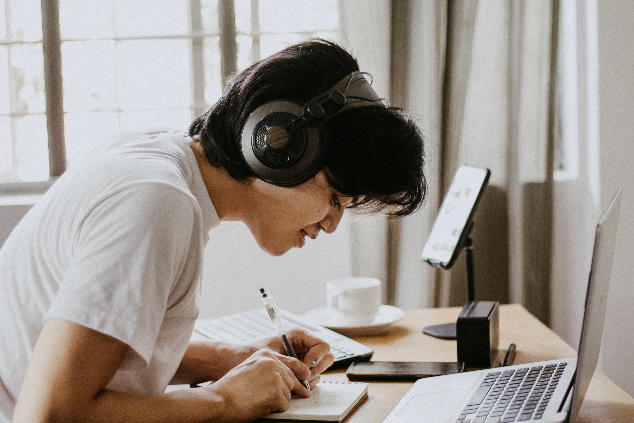 Student with Headphones Using Laptop for Online Class